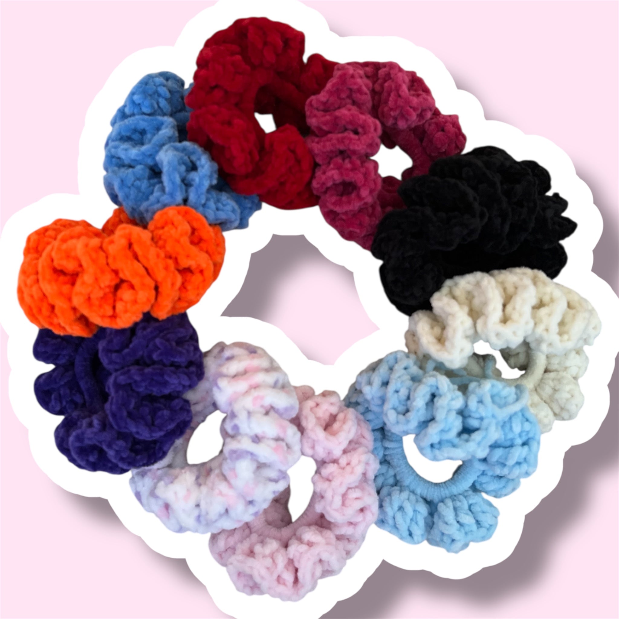 A circle showing 10 different colours of handmade crochet scrunchies on a light pink background