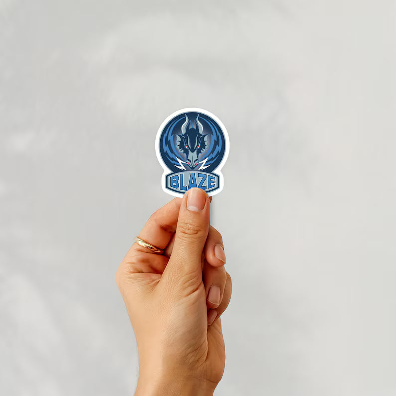 Holding a sticker of coventry blaze ice hockey team logo on a white background