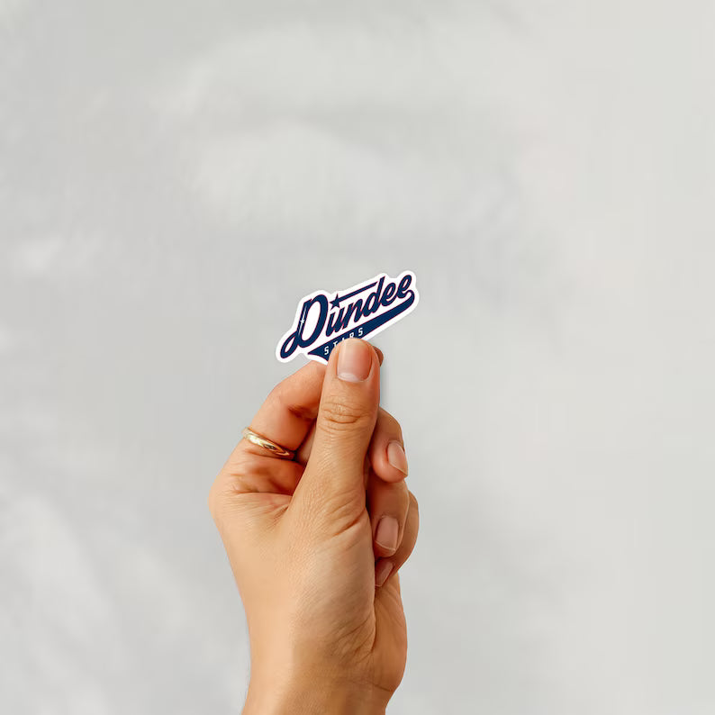 Holding a sticker of dundee stars ice hockey team logo on a white background