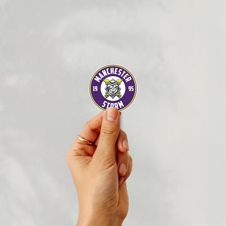 Holding a sticker of manchester storm ice hockey team logo on a white background