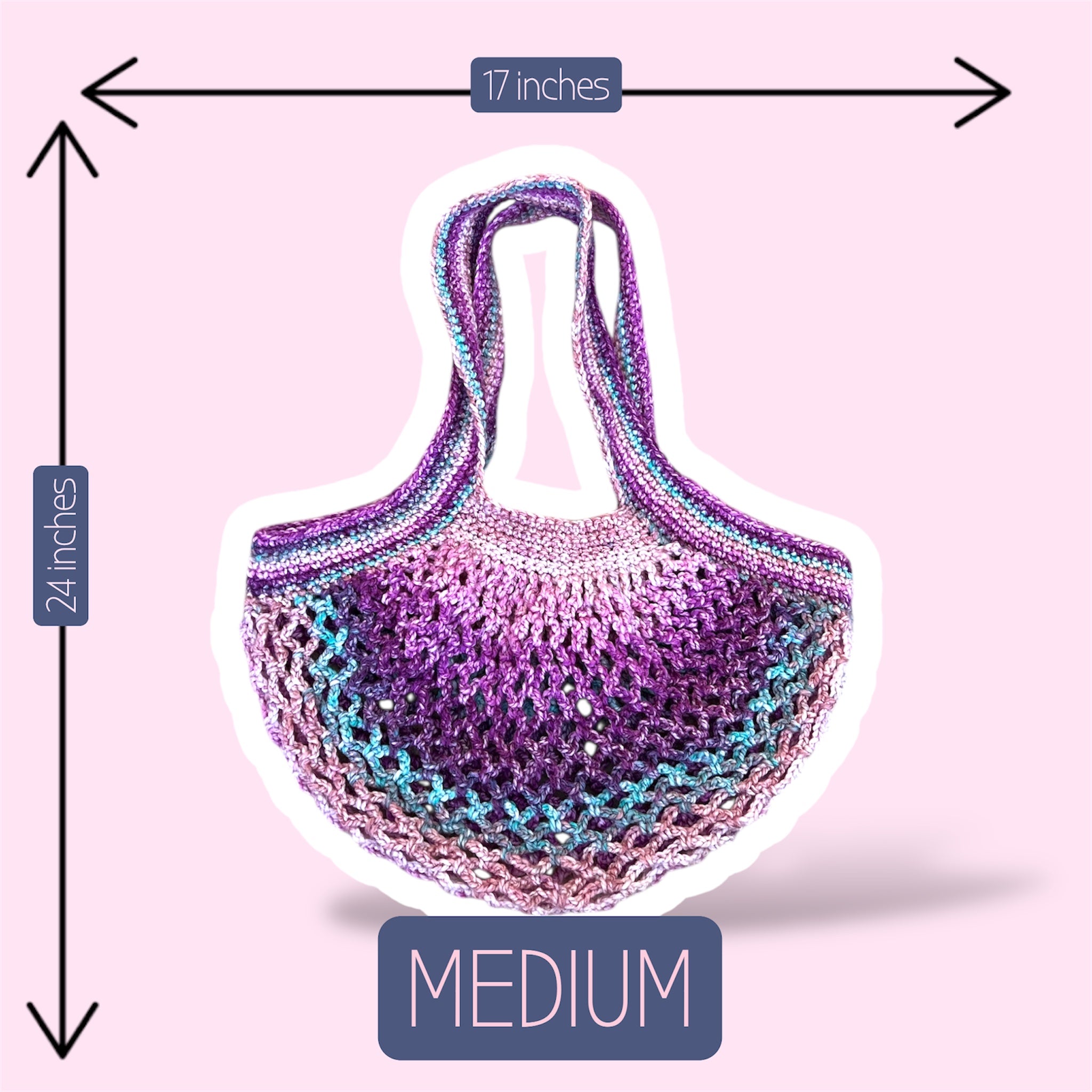 A picture of a purple and pink handmade crochet mesh market bag on a plain light pink background showing the size of the medium version of this bag