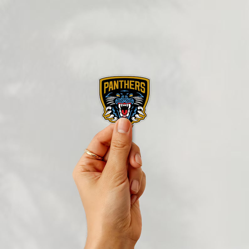 Holding a sticker of nottingham panthers ice hockey team logo on a white background