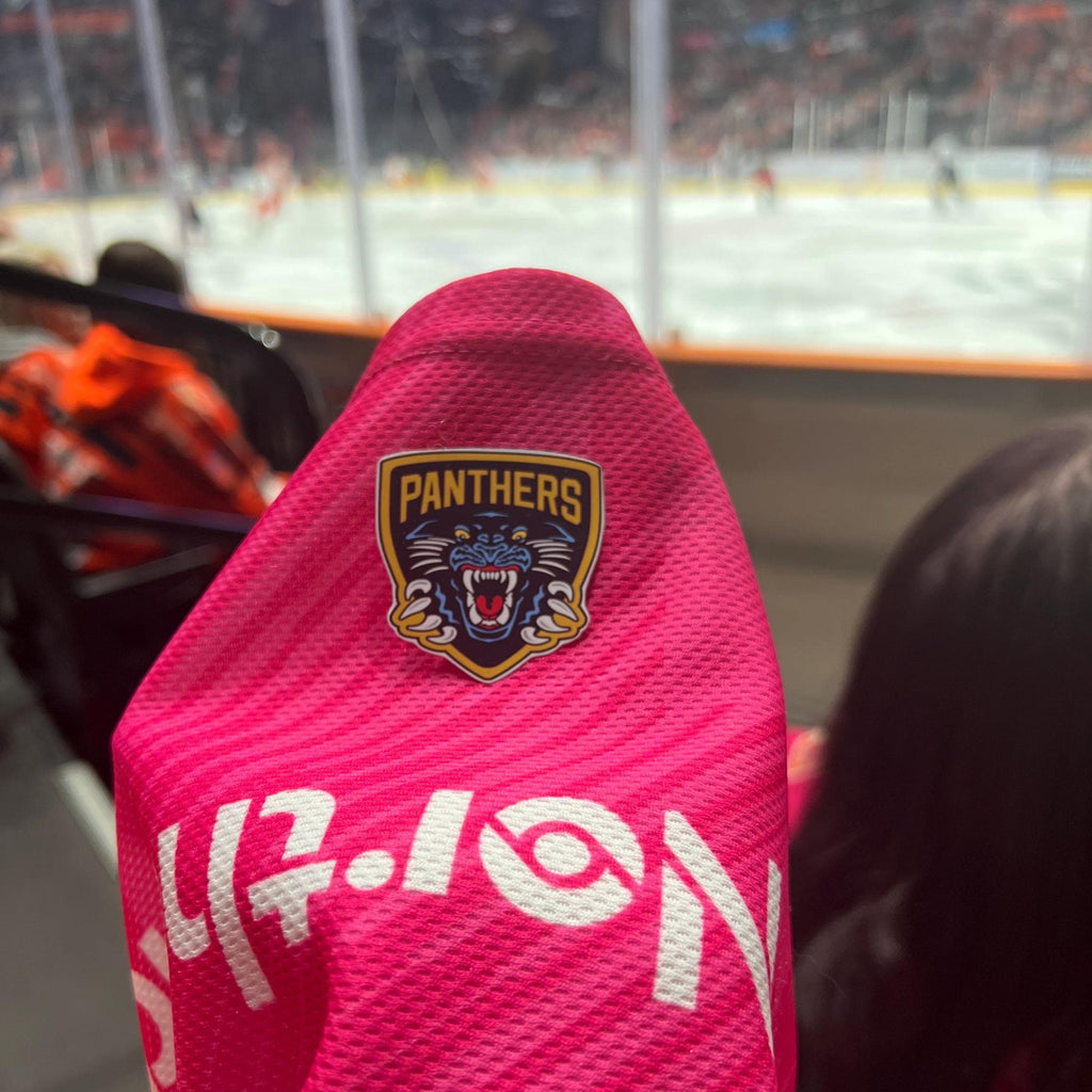 Holding a physical sticker of nottingham panthers ice hockey team logo at an ice hockey game